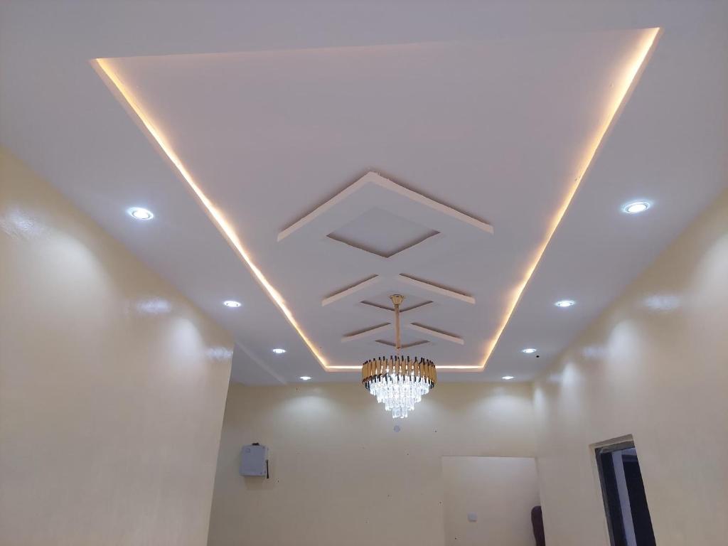 a ceiling with a chandelier in a room at Nikk home in Ado Ekiti