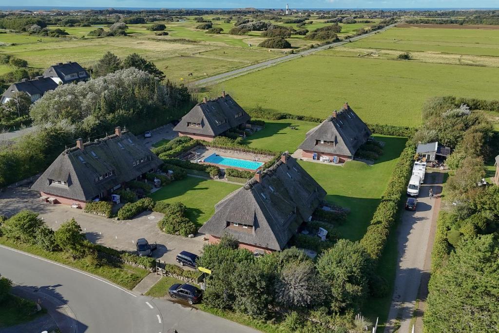 an aerial view of a house with a pool at Lööws Roos in Wenningstedt