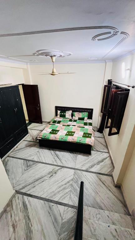 a room with a bed on a tiled floor at Kamlesh Niwas in Rishīkesh