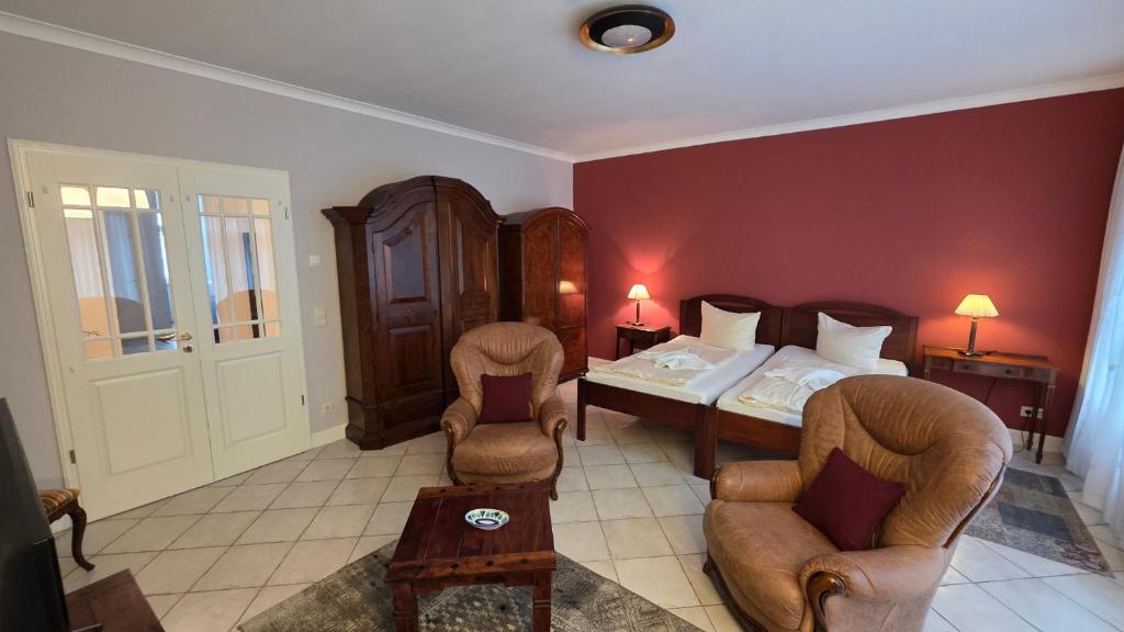 a bedroom with a bed and a table and chairs at Altstadt Zauber in Waren