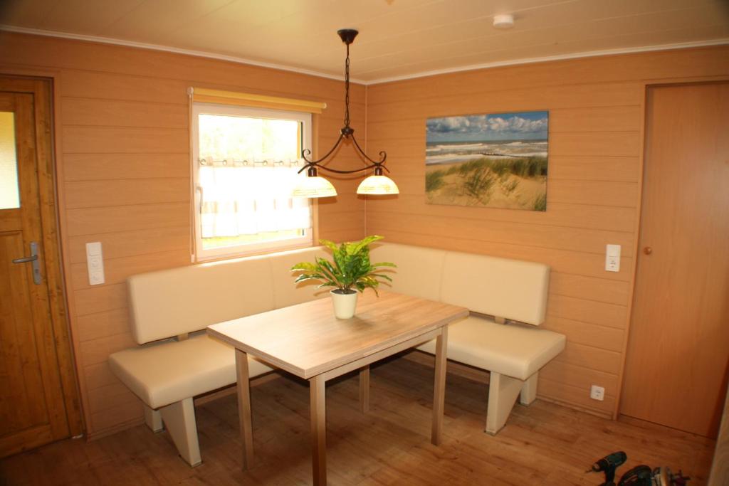 a dining room with a table and two chairs at Bungalow Seedorf 4 in Basedow