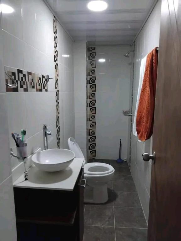 a bathroom with a sink and a toilet at Cabaña los villa in Necoclí