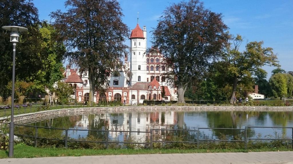 a large building with a pond in front of it at Bungalow Seedorf 7 in Basedow