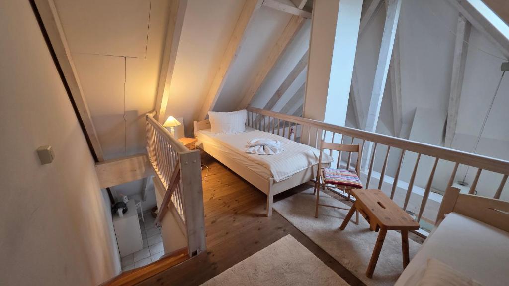 a small room with a bed and a chair on a balcony at Altstadt Loft in Waren
