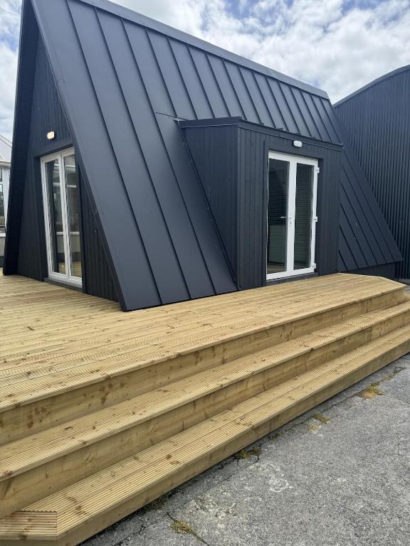 a house with a black roof and a wooden deck at Han's Solo 75 in Athenry