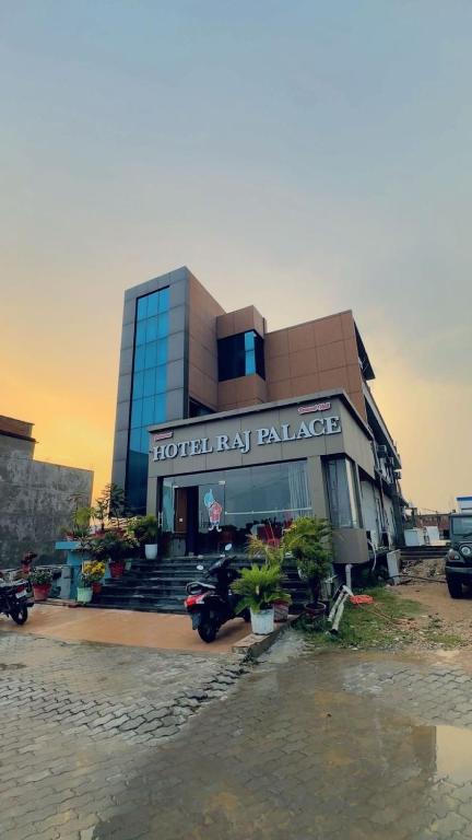 a hotel lax palace with plants in front of it at Hotel Raj Palace in Āzamgarh