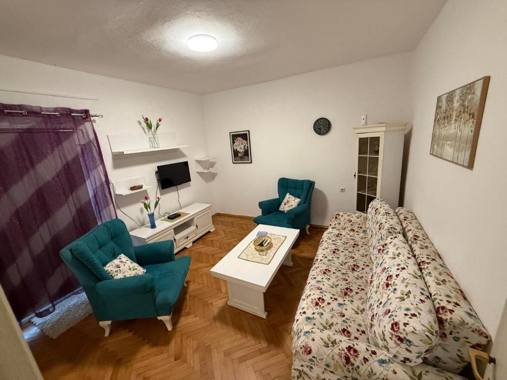 a living room with a bed and two chairs at Old Town view apartment in Bar