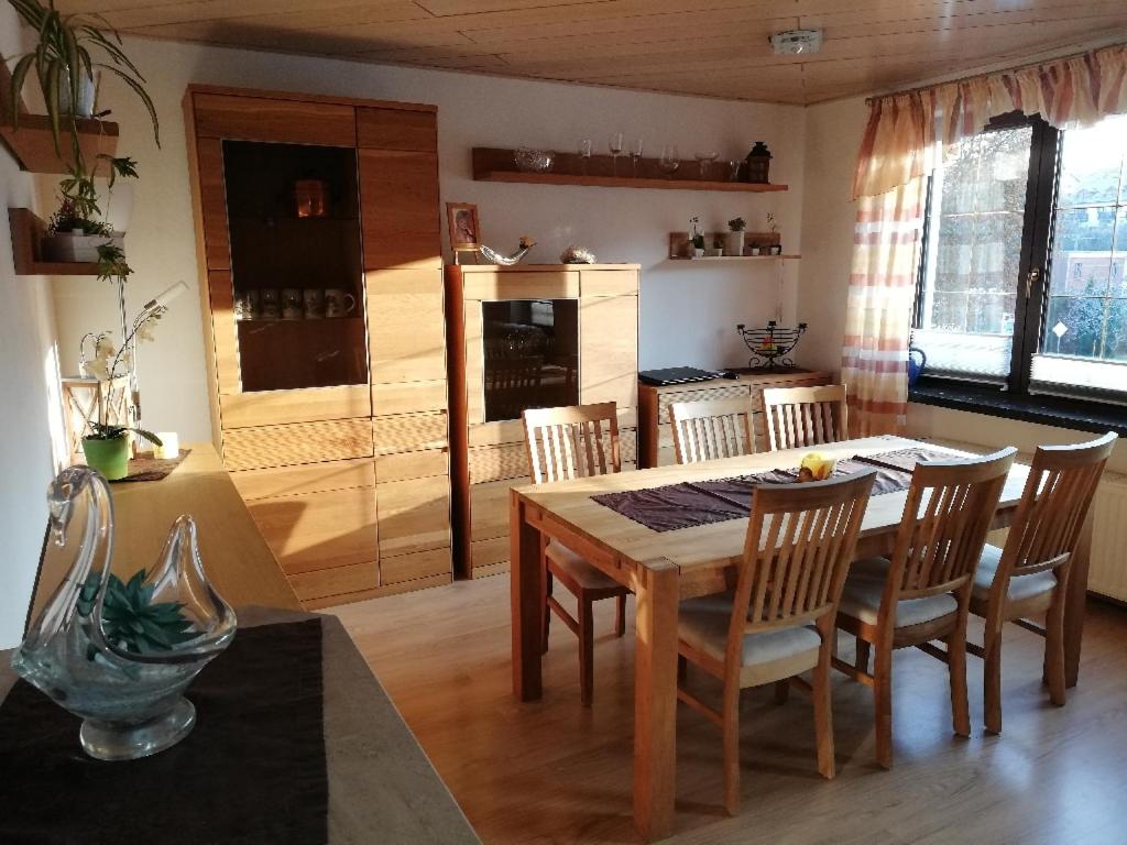a kitchen with a dining room table and chairs at Pension & Ferienwohnung Eitler in Aue-Bad Schlema