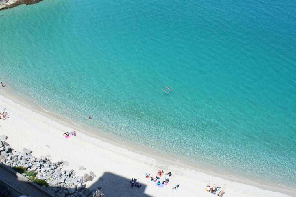 an overhead view of a beach with people in the water at A Casa di Nunzi in Tropea