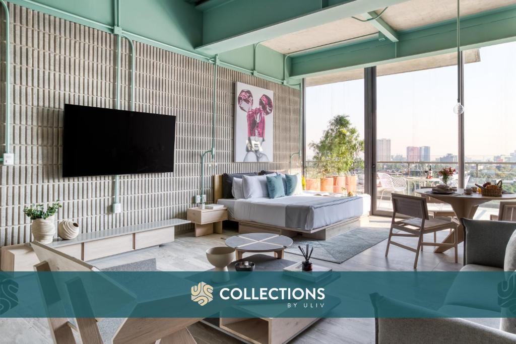 a living room with a couch and a tv at Collections by ULIV Polanco in Mexico City