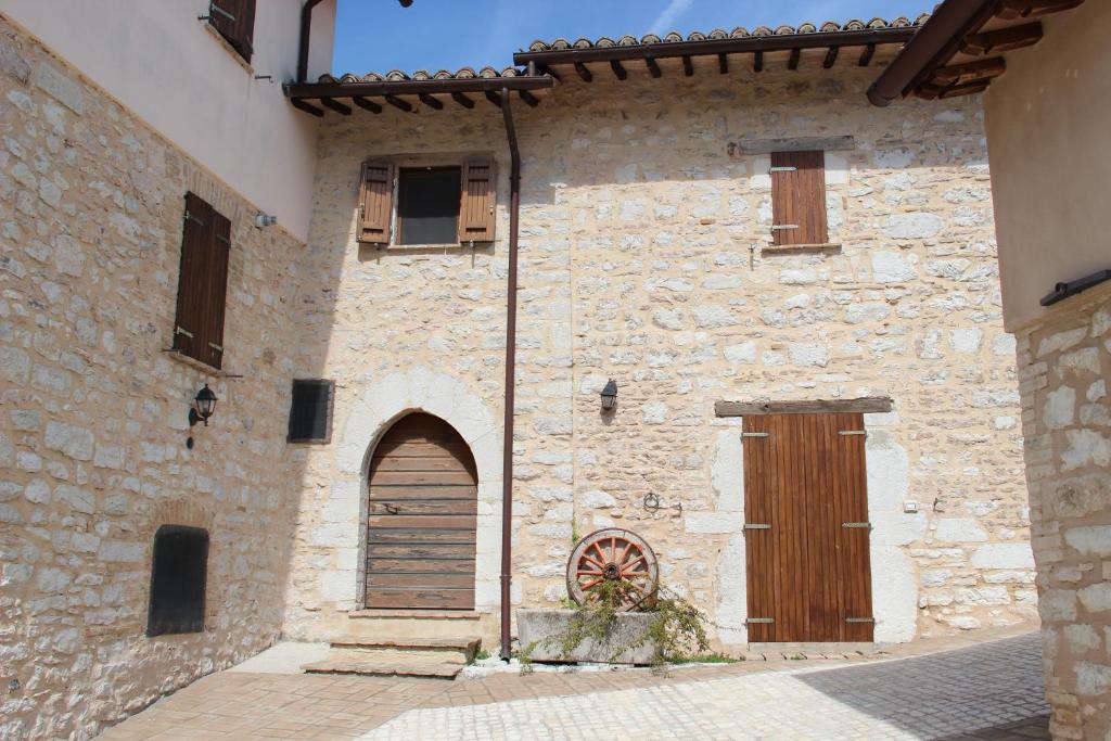 an old stone building with a door and a window at House Morro di Rasiglia in Rasiglia