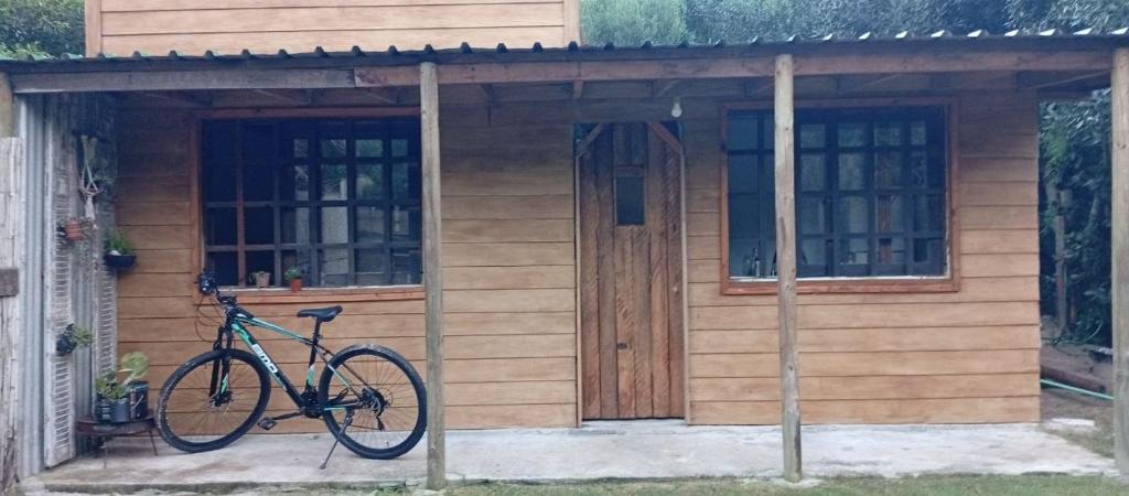 a bike parked in front of a tiny house at Casa en Marindia Sur in Salinas
