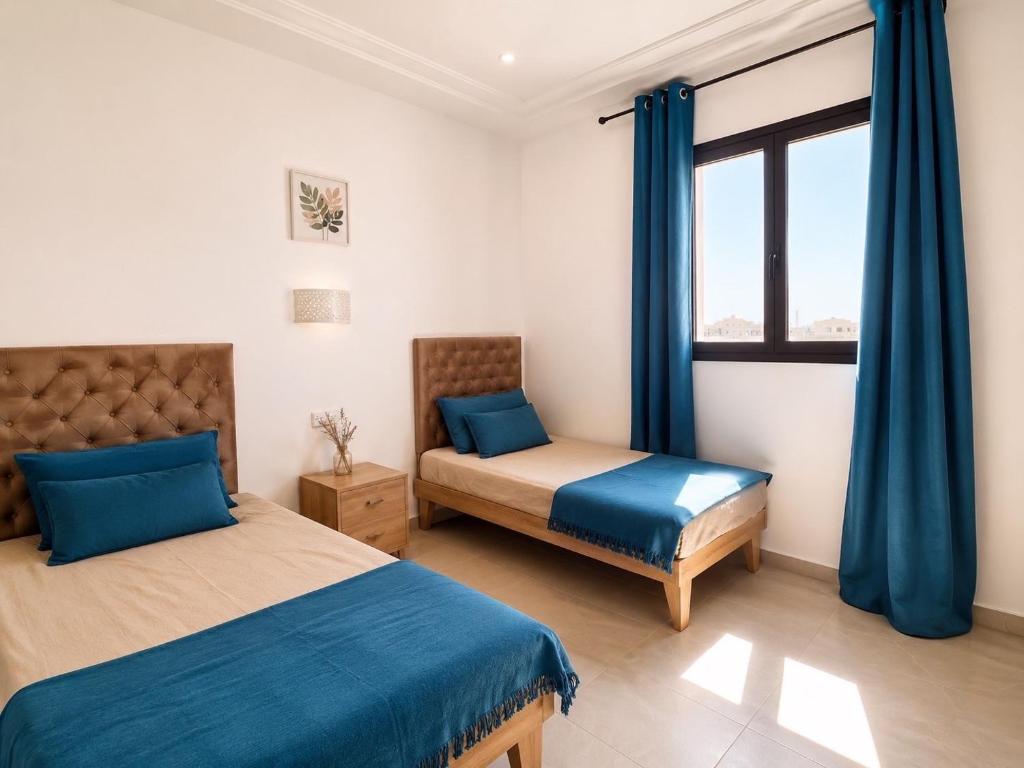 a bedroom with two beds and a window at Villa ines in Taguermess
