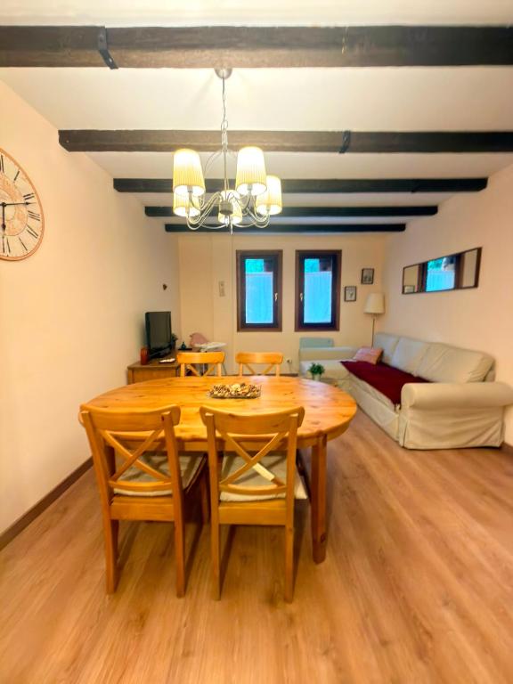 a dining room with a table and a couch at El Boj in Canfranc