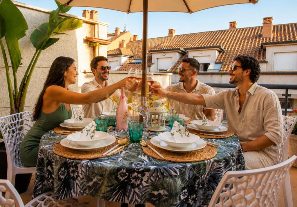 a group of people sitting around a table holding hands at Bienvenido a LaPerla Premium, exclusivo ático con vistas en el corazón de las Rías Baixas in Sanxenxo