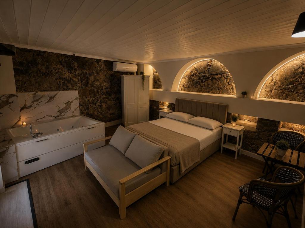 a bedroom with a bed and a bath tub at Aprosmeno House 5 in Agros