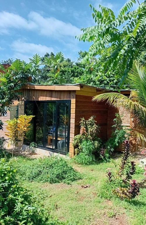 a small house with a large window in a yard at Island Breeze in Negril
