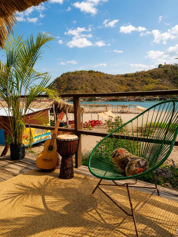 a green chair sitting on a balcony overlooking the beach at Siete Mares in Guayabas