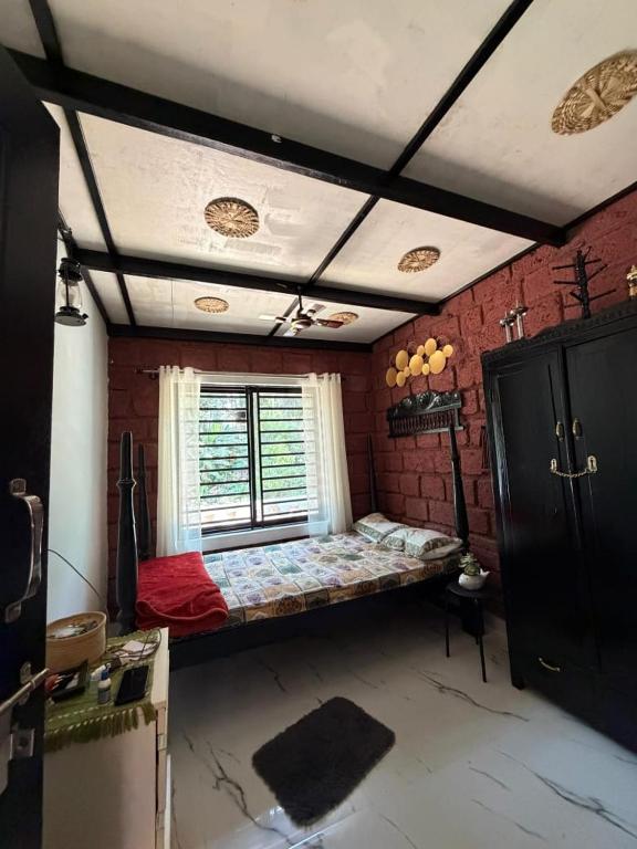 a bedroom with a bed in the middle of a room at Koppalu Heritage in Vastāra