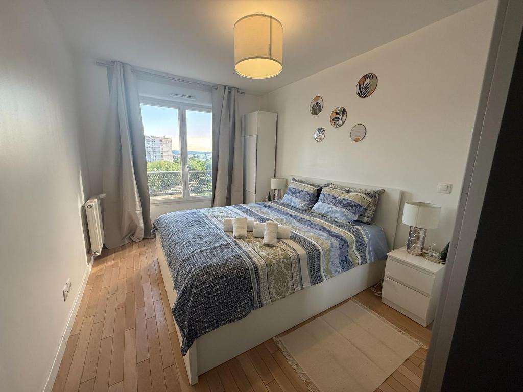 a bedroom with a bed with two candles on it at Cozy Suite La Défense in Nanterre