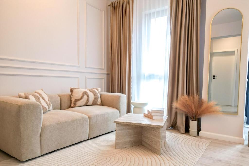 a living room with a couch and a table at Luxury Studio Chiajna in Roşu