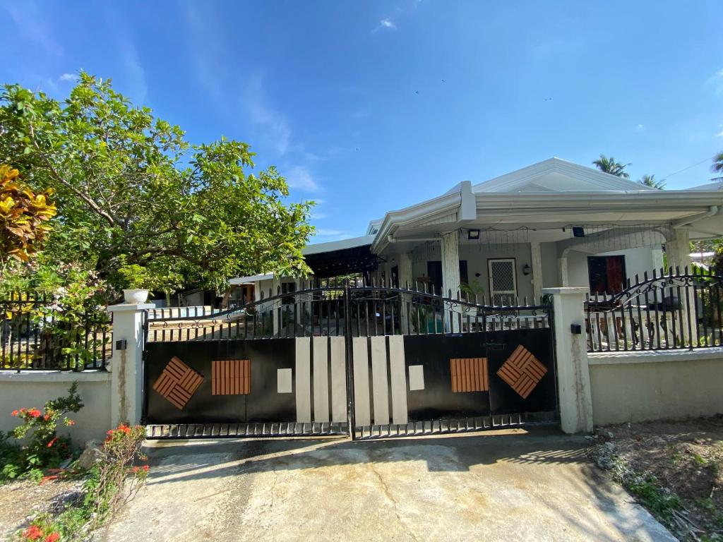 a house with a gate in front of it at MacCreek in Macrohon