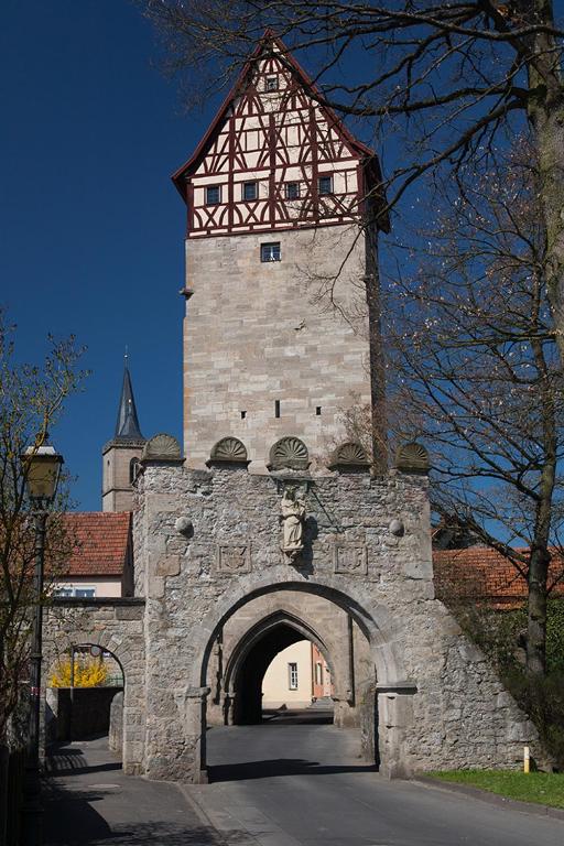 a tall building with a clock tower on top of it at Ankerplatz in Münnerstadt