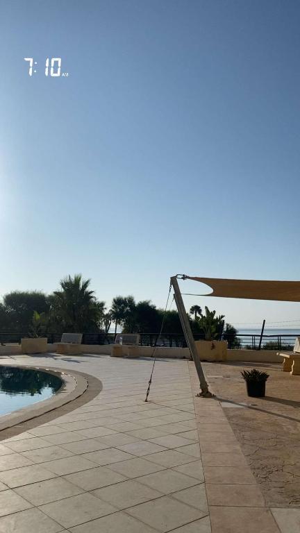 a pole on a patio next to a swimming pool at S1 hammamet mrezga in Nabeul