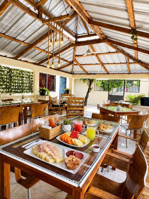 a table with many plates of food on it at bon Appetit Hotel restaurant barahona in Isleta de Barahona