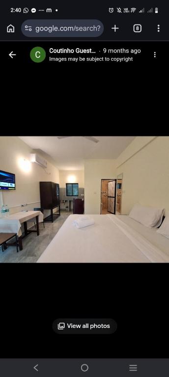 a picture of a bedroom with a bed and a tv at Coutinho Guest House in Panaji