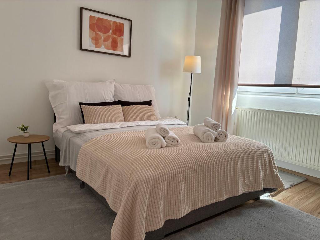 a bedroom with a bed with two towels on it at AeraSuites Komárom in Komárom