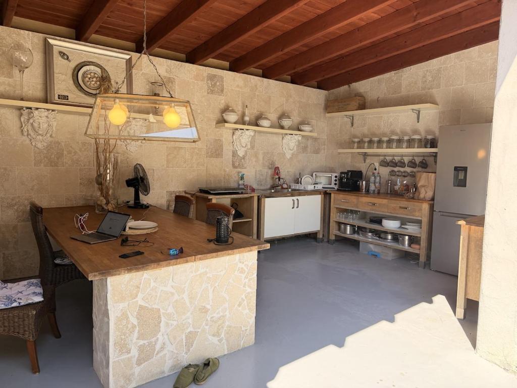 a large kitchen with a table and a counter at La Villa Fafouille in Cavalaire-sur-Mer