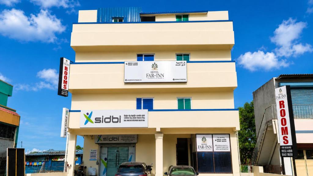 a building with a sign on top of it at Hotel Far-Inn in Irungattukottai