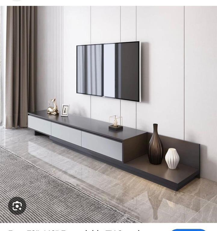 a living room with a television on a wall at JOHNOATCH APARTMENt in Ibasa