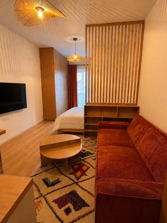 a living room with a couch and a bed at Rose Joséphine in Ajaccio
