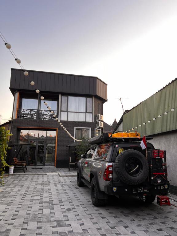 a suv parked in front of a building at Guest House Cube "Frunze" in Osh