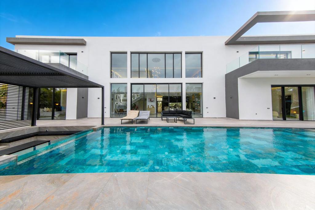 a swimming pool in front of a house at Villa Horizon Marrakech in Marrakesh