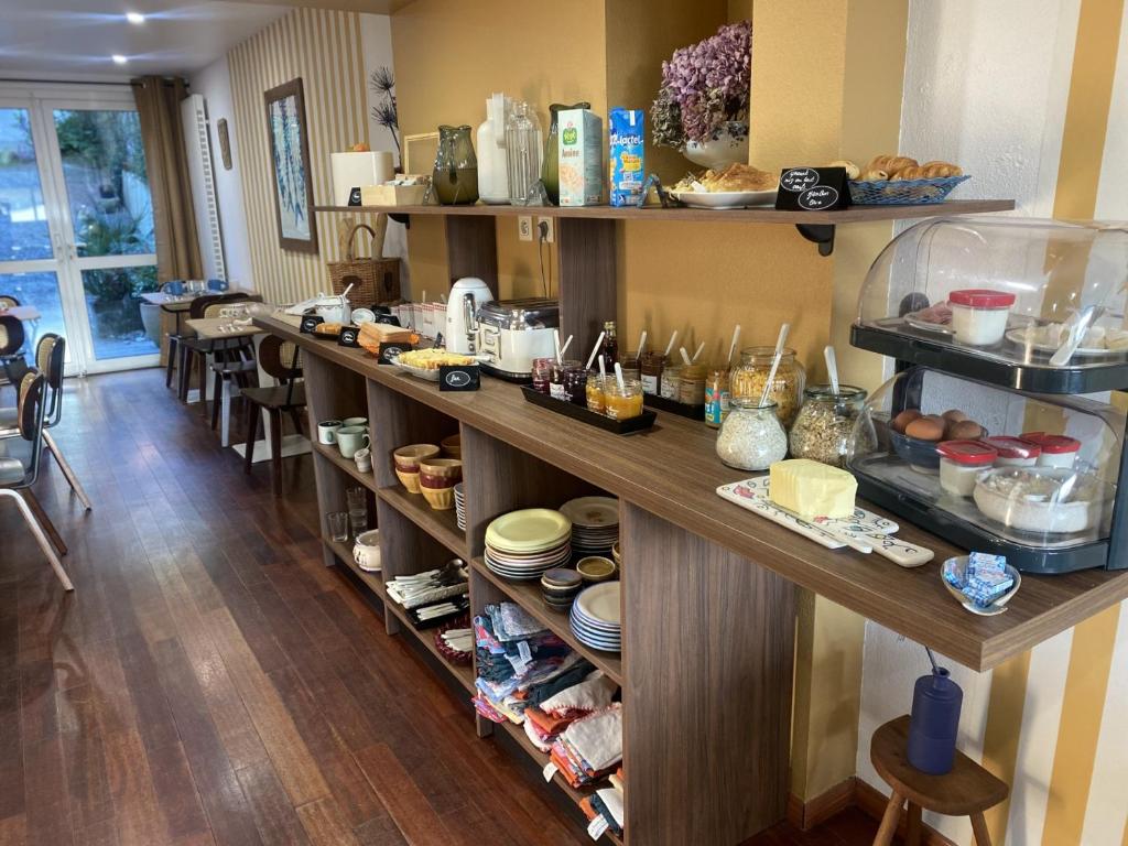 a kitchen with a long counter with food on it at Louis Hotel in Perros-Guirec