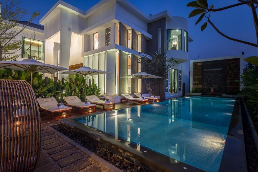 a house with a swimming pool in front of a house at Shintana Saya Residence in Siem Reap