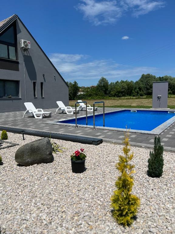 a house with a swimming pool in a yard at Villa Jovičić in Prijedor