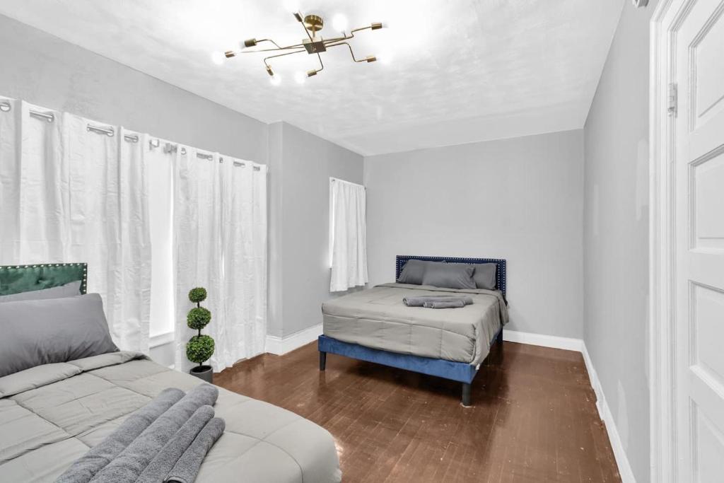 a bedroom with two beds and a ceiling fan at 5-Bed Home Game Room Pool Table Sleeps 13 in Buffalo