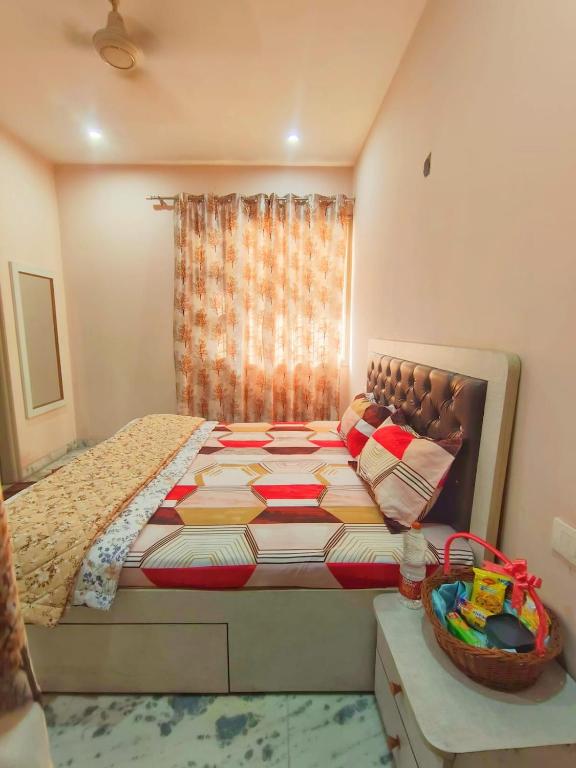 a bedroom with a bed and a window at Om Homestay in Panchkula