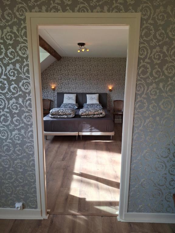 a bedroom with a bed and a large mirror at C'est Si Bon in Vandenesse