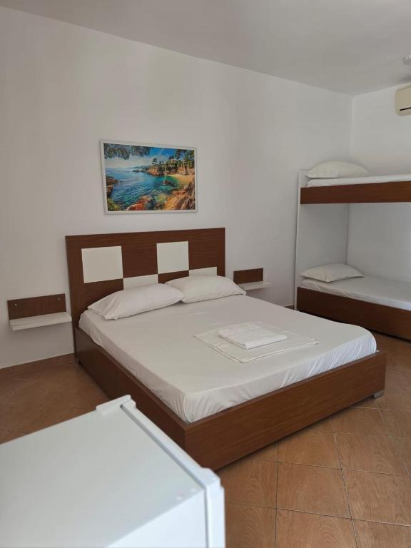 a bedroom with two beds and two bunk beds at Vila Hana in Dhërmi