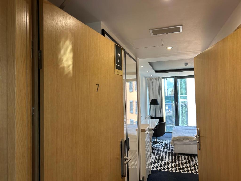 an open door to a room with a bedroom at Apartament Piano 21 in Opole