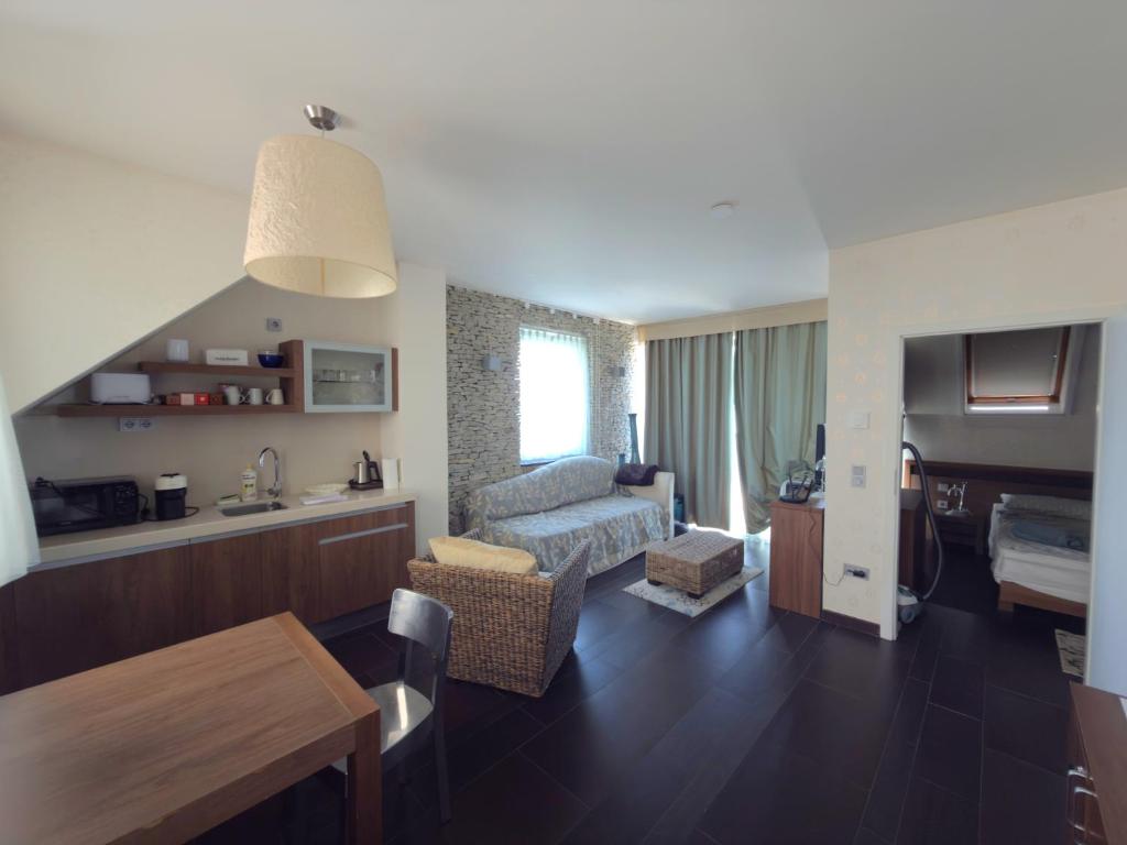 a living room with a couch and a table in a room at Tihany Panoráma Apartman in Tihany