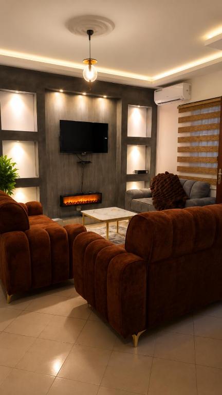 a living room with a couch and a fireplace at MANDJOU résidence in Abidjan