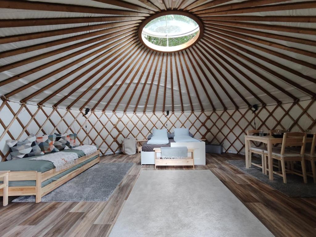 a room with a bed and a window in a yurt at Jurte Falkenauge Schweiz in Schönengrund