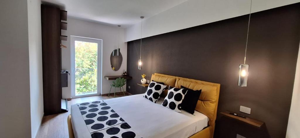 a bedroom with a large bed with black and white pillows at Luana in Caltagirone