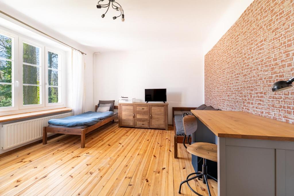 a living room with a couch and a table at Dwupoziomowy apartament, 4 pokoje in Dęblin